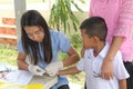 The doctor is taking blood from primary student.